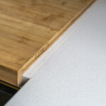 Imperial White Quartz worktop close-up with a wooden chopping board resting on the smooth white surface