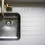 Top-down view of an Imperial White Quartz worktop with an inset sink and drainer grooves