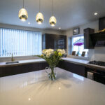 Wide kitchen view featuring an Imperial White Quartz island worktop with a bright, smooth finish