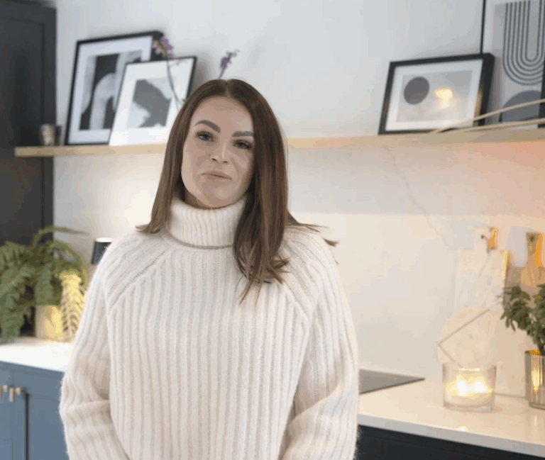 Renee in her kitchen with Olympus White Quartz worktops and subtle grey veining in the background