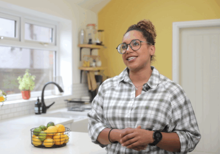 Alanna in her kitchen with Ice White Quartz worktops visible in the background near the sink and island