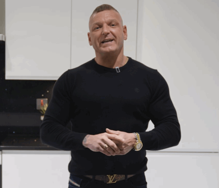 Dean customer testimonial image in a kitchen with Black Starlight Quartz worktop visible in the foreground