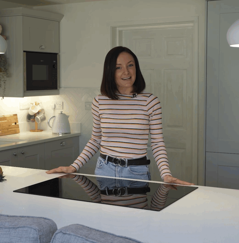 Lizzie giving a testimonial in her kitchen featuring Aspen Shimmer Quartz worktops