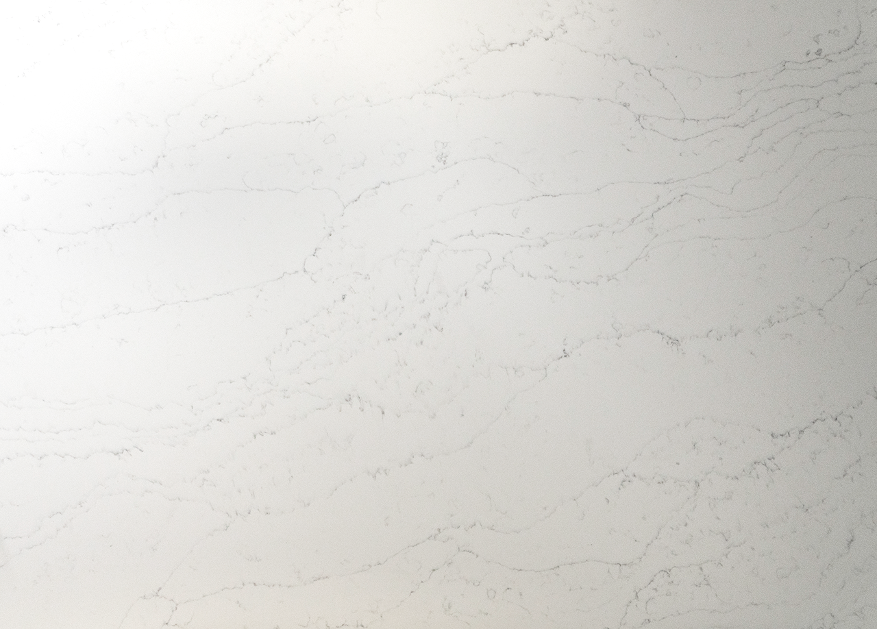 Close up of Statuario Bianco Porcelain surface showing delicate grey veining on a white base