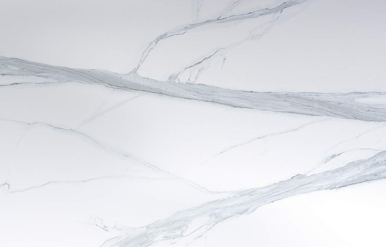 Volakas White Porcelain slab close up showing soft grey veining across a bright white background