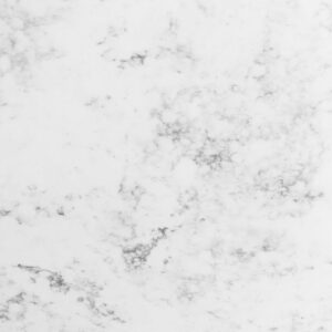 Close-up of Arabescato Quartz slab showing soft grey veining and a polished white finish