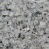 Close up slab photo of Azul Platino Granite showing a light grey base with black and silver crystal flecks and a fine natural grain.