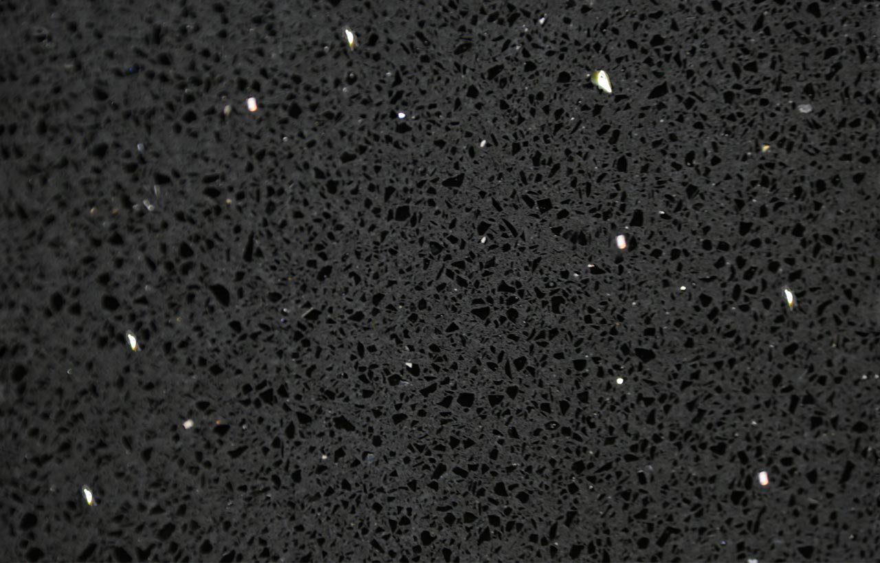 Close-up of Black Starlight Quartz slab showing fine speckled texture and reflective flecks in a black finish