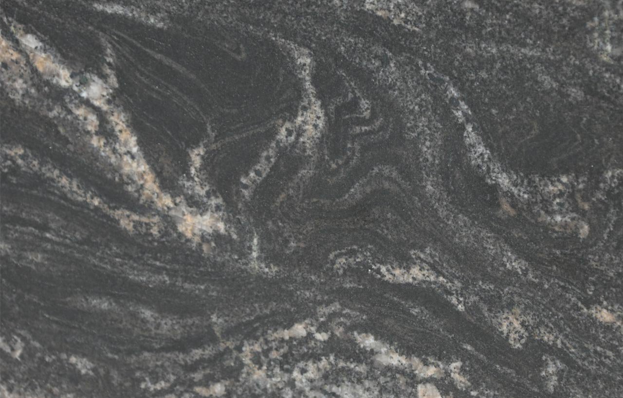 Close up slab photo of Black Storm Granite showing dramatic swirling veining and natural movement in dark tones.