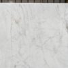 Carrara Venato Gold Porcelain close-up showing a light marble effect background with soft grey veining and warm gold accents