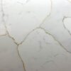 Close up of Gold Calacatta worktop surface showing warm natural veining