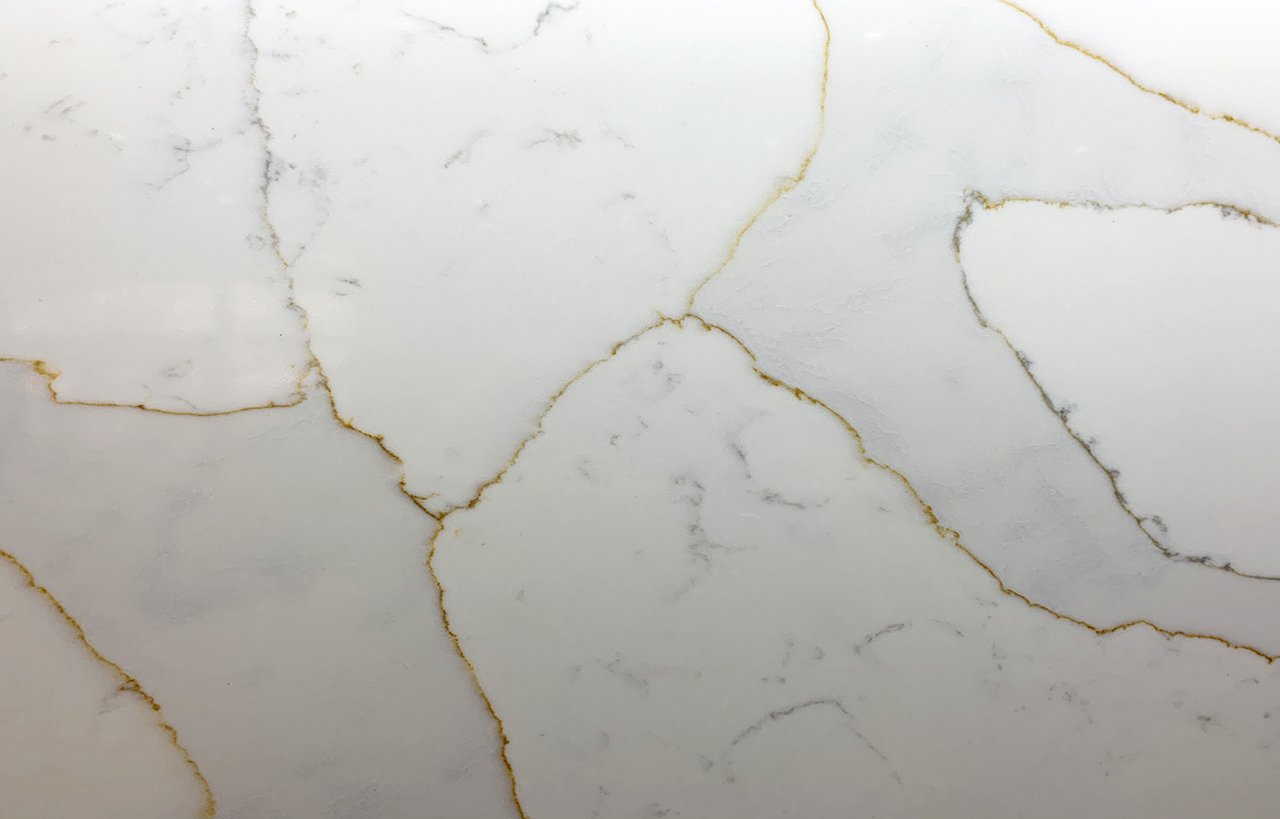 Close up of Gold Calacatta worktop surface showing warm natural veining