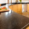 Curved kitchen worktop in Nero Cosmos Granite with a polished finish, showing the rounded edge detail and sparkling flecks under light.