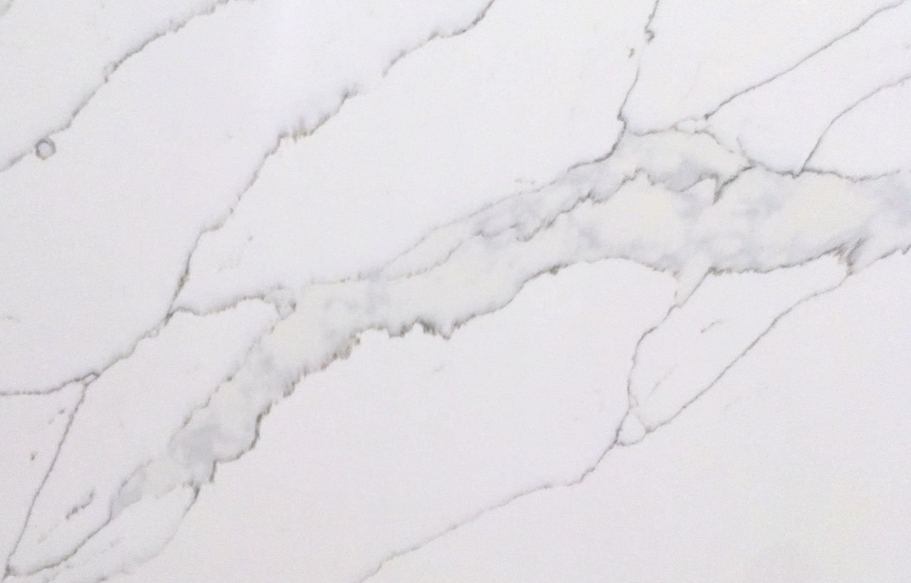White Calacatta Quartz surface showing bold grey veining on a bright white background