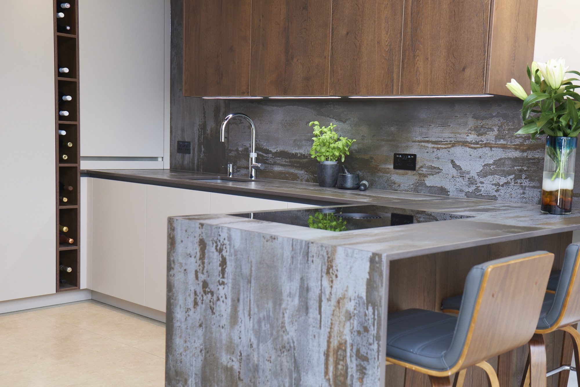Trilium Porcelain kitchen island worktop with waterfall end panel, inset sink, and chrome tap in a modern kitchen