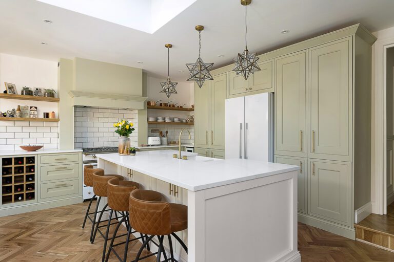 Large kitchen island fitted with Eternal Calacatta Quartz worktops in a bright modern kitchen