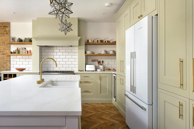 Eternal Calacatta Quartz worktops in a modern kitchen with sage cabinets and white fridge