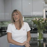 Customer testimonial still filmed in a kitchen after an Absolute Black Granite worktop installation by Mayfair Worktops, showing the worktop area behind.