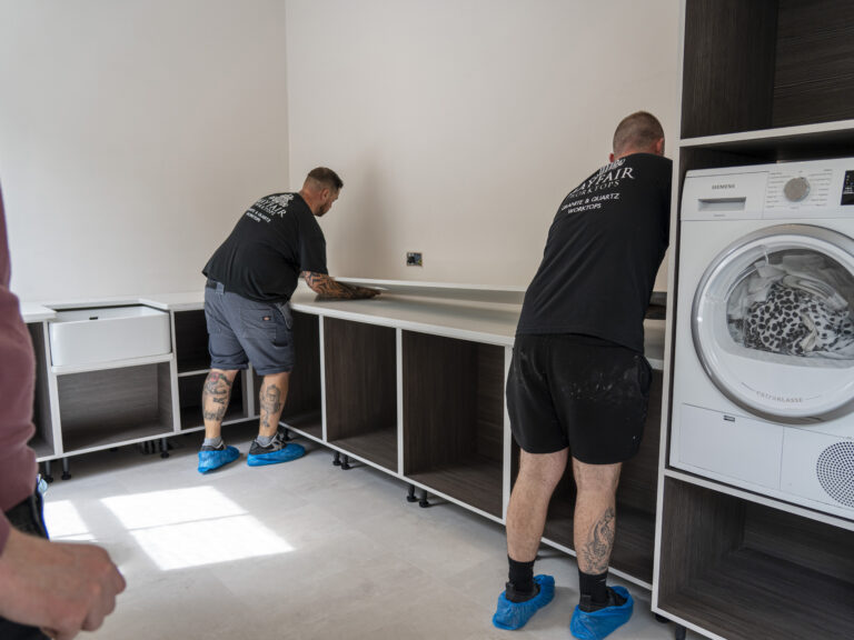 Installation process of Carrara Quartz worktops in a modern home