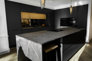 Laurent Porcelain kitchen island worktop installed with a dark stone-look finish and subtle veining, shown in a modern kitchen setting.