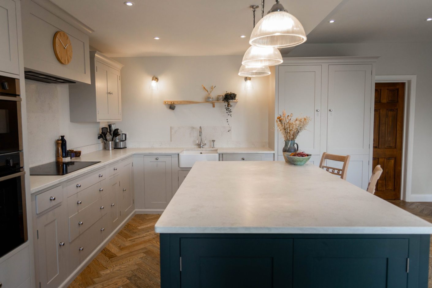 White Concrete Quartz worktops fitted to a large island and perimeter run in an open-plan kitchen layout