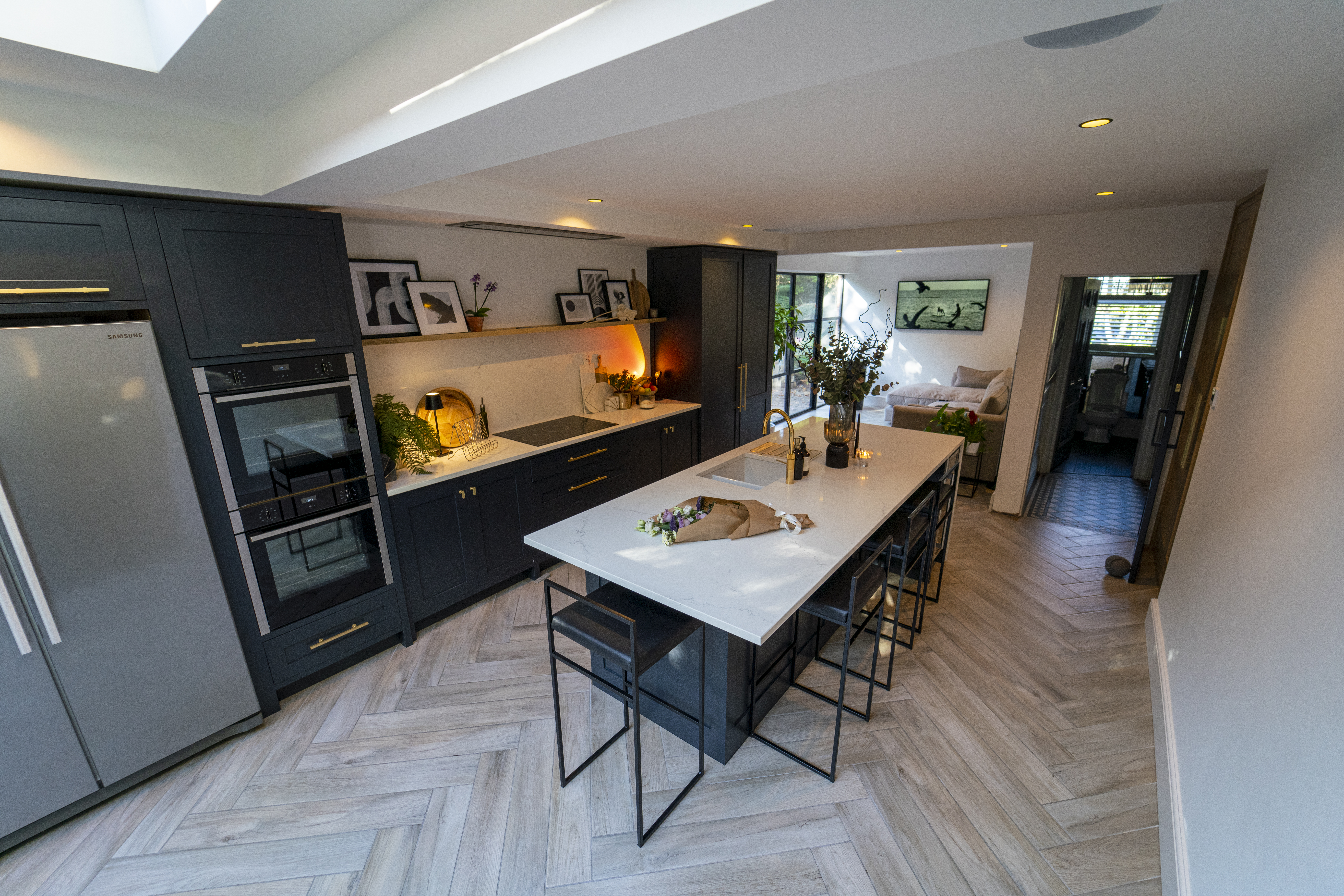 Kitchen dining area with an Olympus White Quartz island worktop showing soft veining across the surface