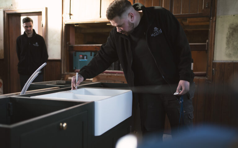 Stonemason using digital templating equipment to measure Carrara Quartz worktop layout