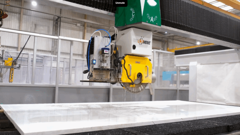 CNC machine cutting a Volakas White Porcelain slab in the Mayfair Worktops workshop, shown during the machining process.