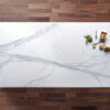 Volakas White Porcelain slab close up showing soft grey veining across a bright white background