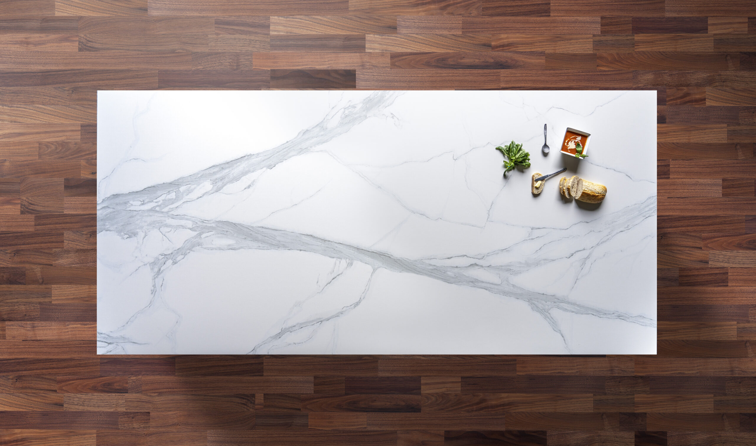 Volakas White Porcelain slab close up showing soft grey veining across a bright white background