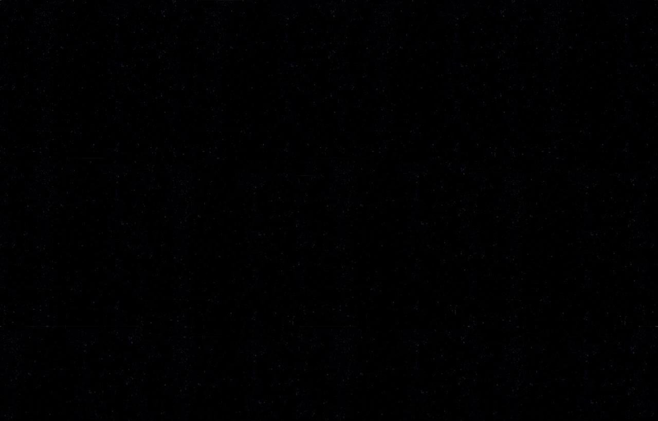 Close up slab photo of Absolute Black Granite showing a deep black tone with a polished finish and subtle light reflection.