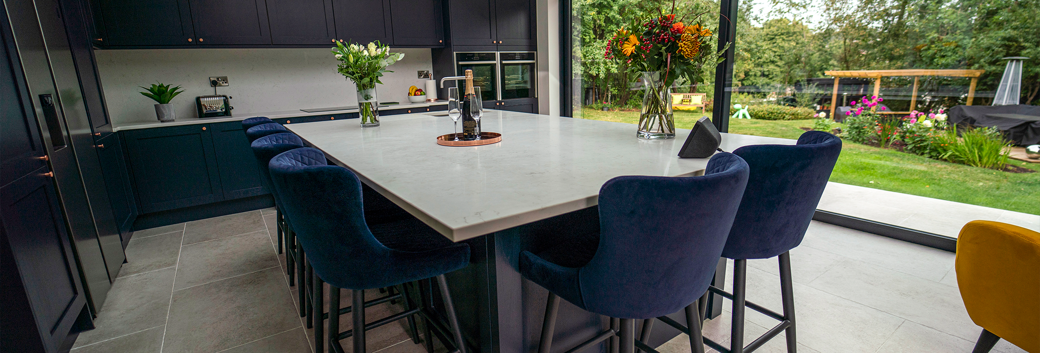 Carrara Quartz worktops in a modern kitchen with waterfall island and subtle grey veining