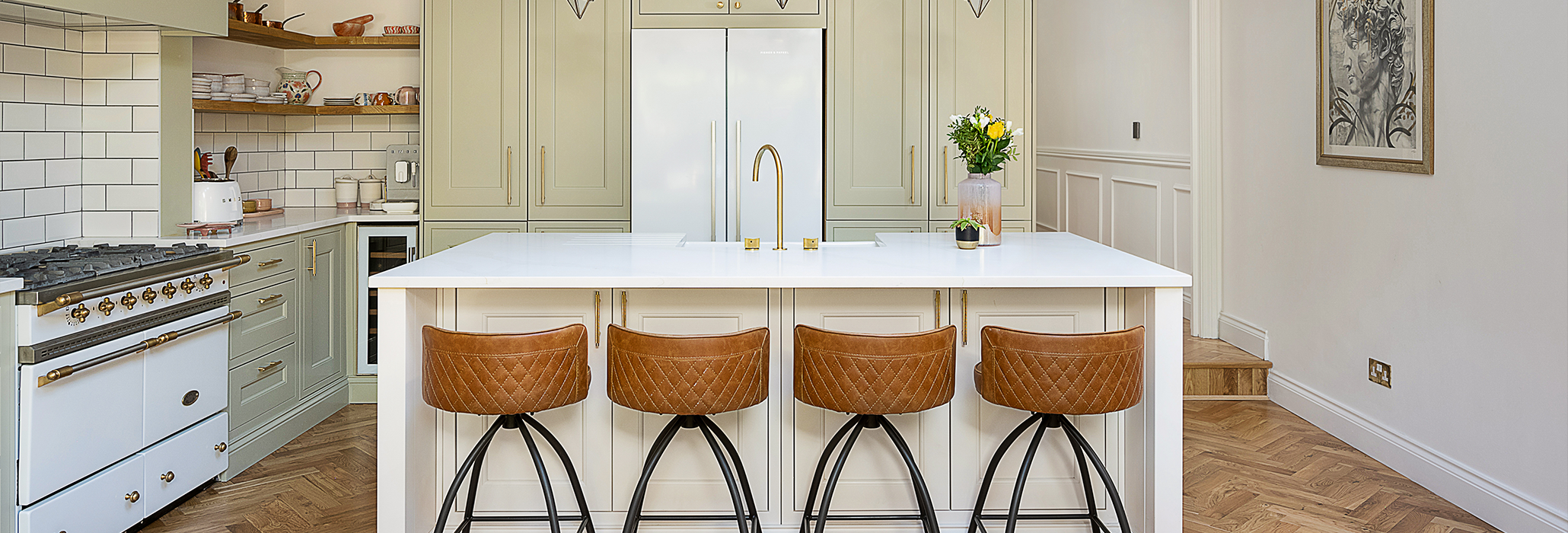 Large kitchen island with Eternal Calacatta Quartz worktop and four barstools in a modern bright kitchen