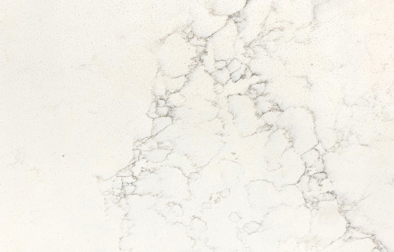 Close-up of Olympus White Quartz slab showing soft grey veining across a bright white surface