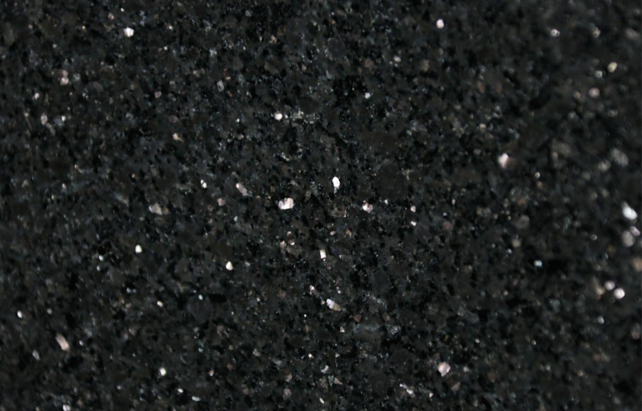 Close up slab photo of Star Galaxy Granite showing a deep black base with dense sparkling flecks and natural crystal patterning.